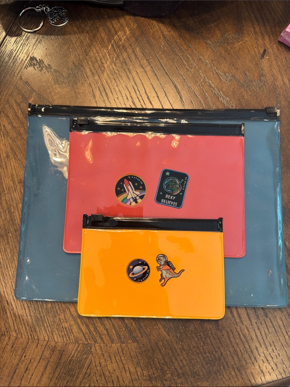Coach Vinyl Rexy Pouch Trio in Blue, Coral and Orange - Picture 2 of 5